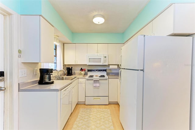 kitchen featuring white appliances, light hardwood / wood-style flooring, white cabinetry, and sink