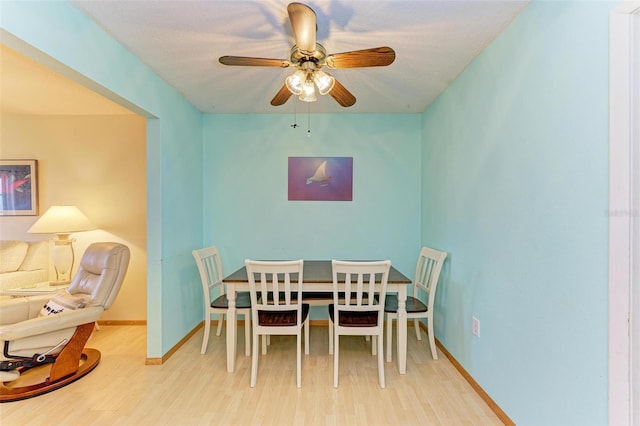 dining room with light hardwood / wood-style flooring and ceiling fan