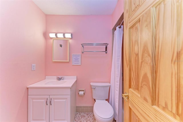 bathroom featuring vanity, a textured ceiling, and toilet