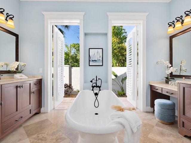 bathroom with a washtub and vanity