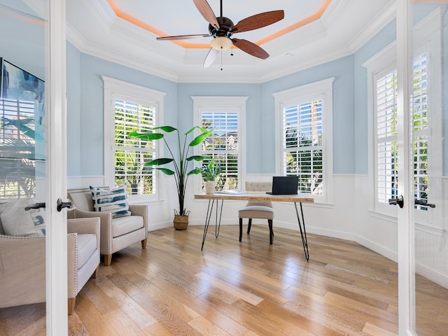 office area featuring a tray ceiling, a wealth of natural light, crown molding, and french doors