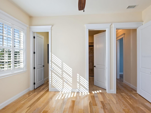 spare room featuring light hardwood / wood-style flooring and ceiling fan