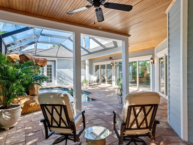 sunroom / solarium featuring ceiling fan and wooden ceiling