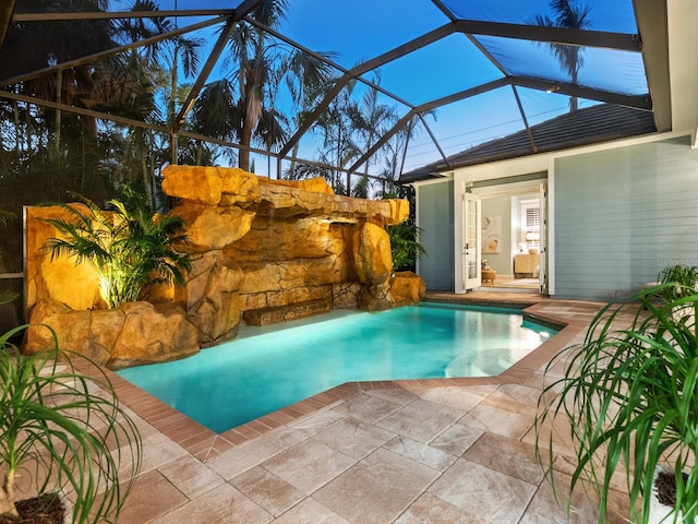 view of swimming pool featuring a lanai and a patio