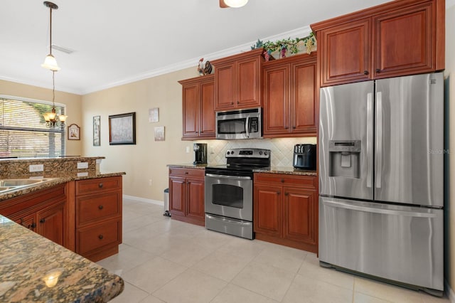 kitchen featuring backsplash, stainless steel appliances, decorative light fixtures, a notable chandelier, and stone counters