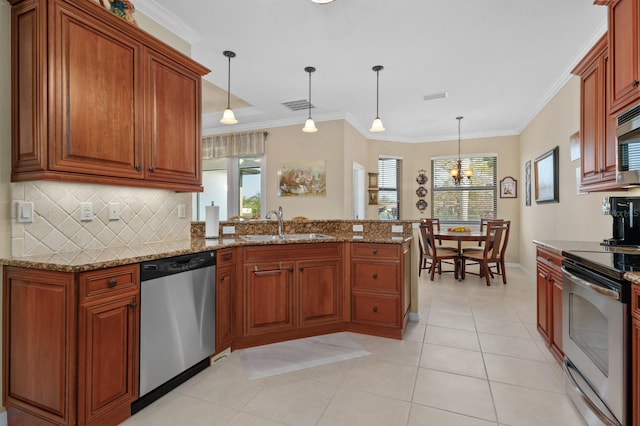 kitchen with kitchen peninsula, stainless steel appliances, decorative light fixtures, and ornamental molding