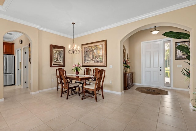 dining area with a chandelier, crown molding, and light tile patterned flooring