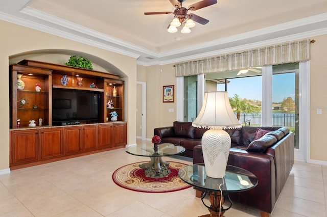 living room with ceiling fan, light tile patterned flooring, and crown molding