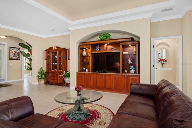 tiled living room with a tray ceiling and ornamental molding