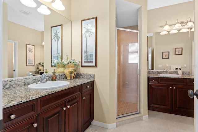 bathroom with vanity, tile patterned floors, and a shower with shower door