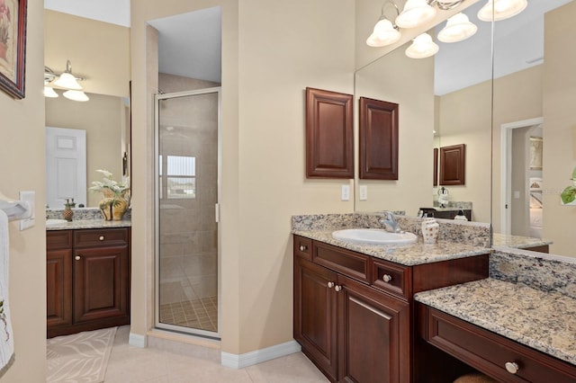 bathroom featuring vanity, an inviting chandelier, tile patterned floors, and an enclosed shower