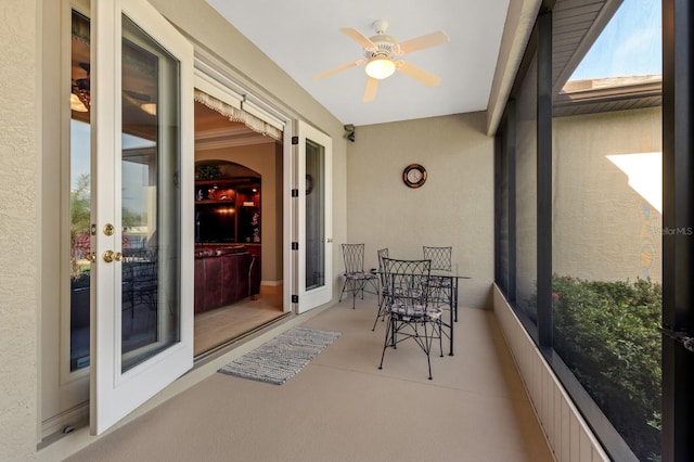 sunroom / solarium featuring ceiling fan