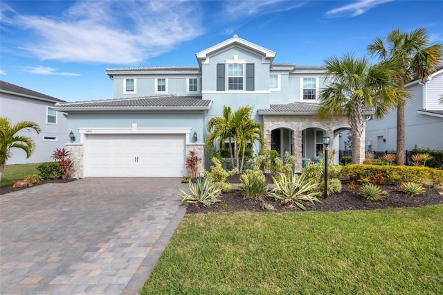 view of front of property with a front yard and a garage