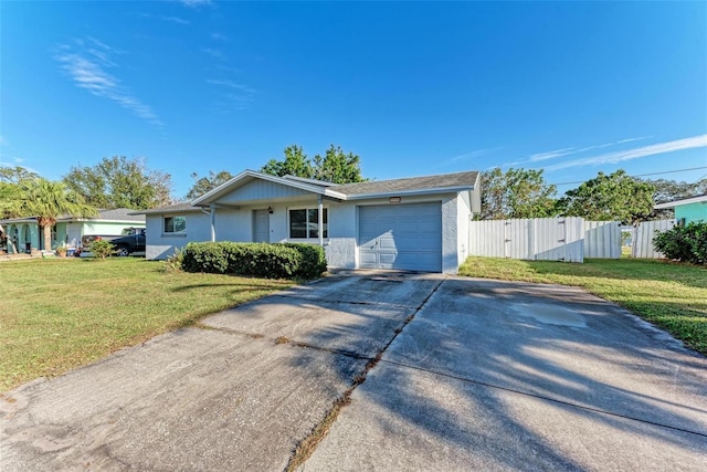 single story home featuring a garage and a front lawn