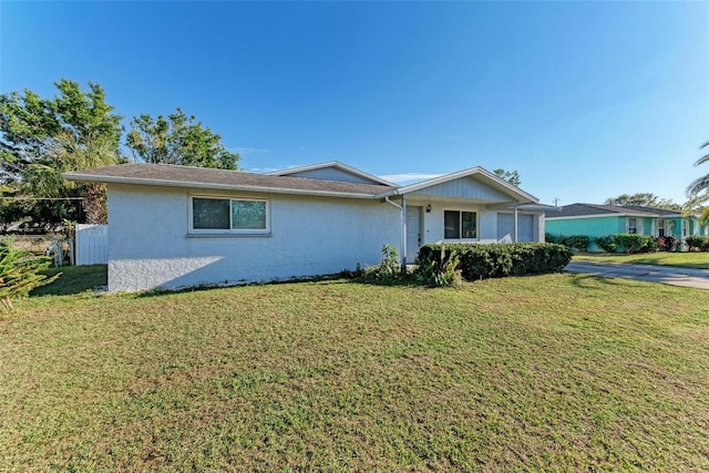 single story home featuring a front yard