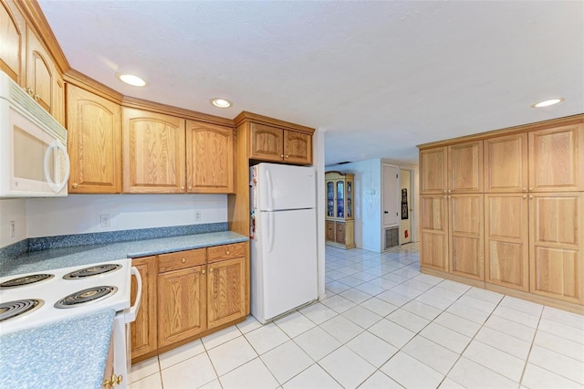 kitchen with light tile patterned flooring and white appliances