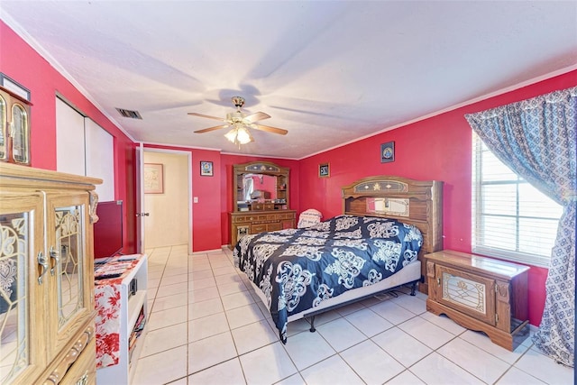 tiled bedroom featuring ceiling fan and ornamental molding