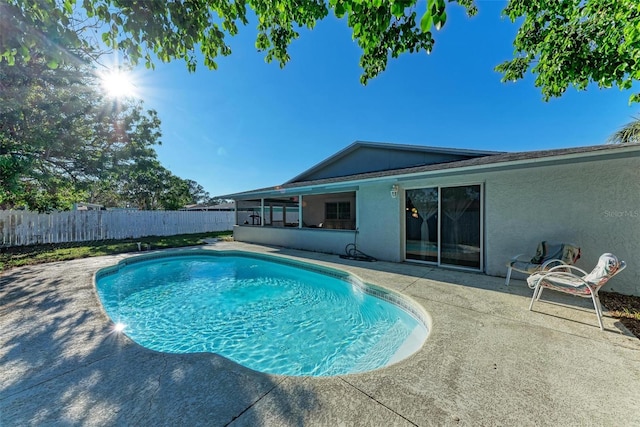 view of pool with a sunroom and a patio area