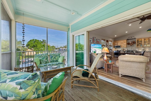 sunroom / solarium with ceiling fan and lofted ceiling