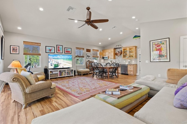 living room with ceiling fan, lofted ceiling, and light wood-type flooring