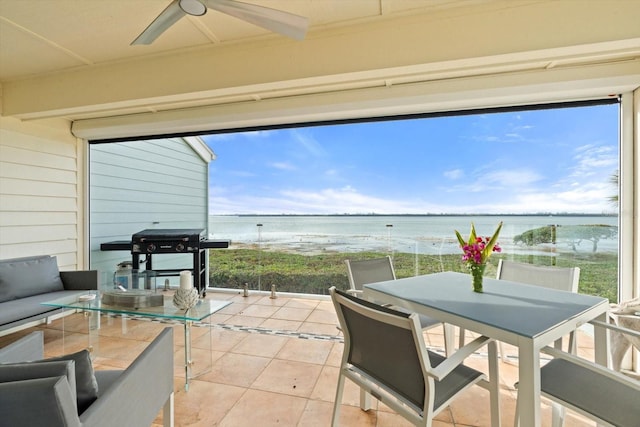 exterior space with a water view and ceiling fan