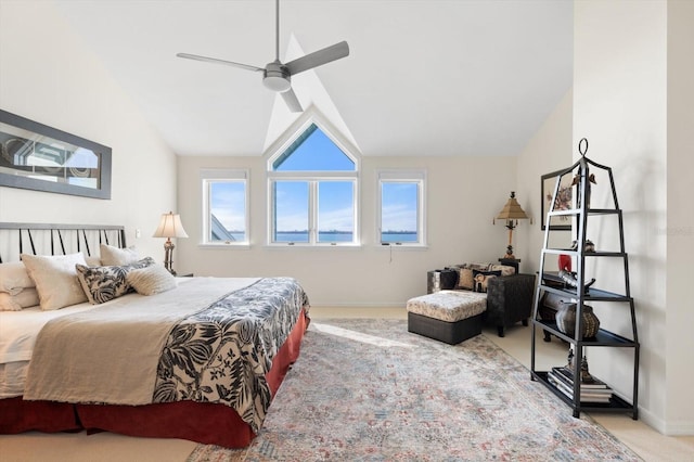 bedroom featuring ceiling fan, light carpet, and vaulted ceiling