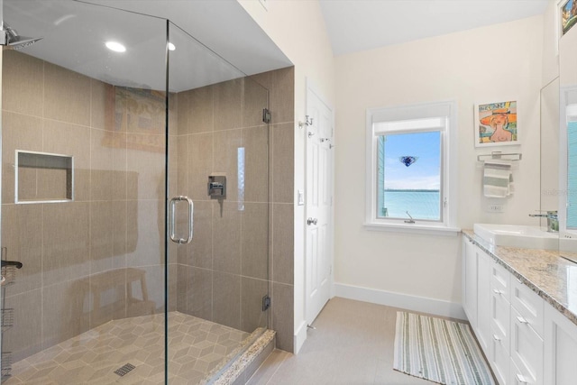 bathroom with tile patterned flooring, vanity, and an enclosed shower