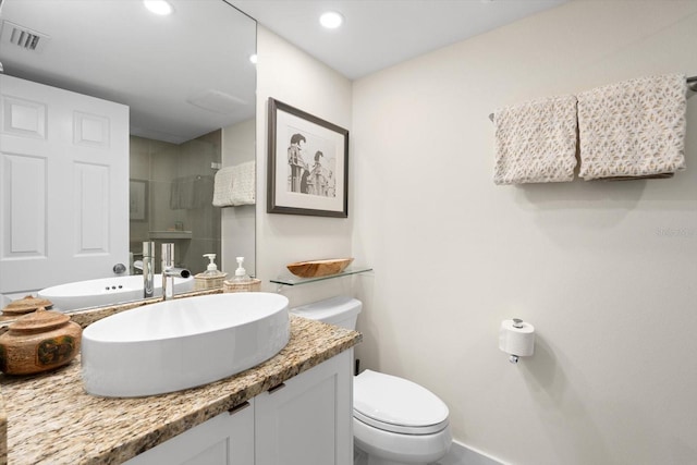 bathroom featuring vanity, an enclosed shower, and toilet