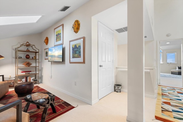 interior space featuring light colored carpet and lofted ceiling