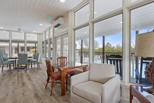 sunroom with a wall mounted air conditioner, ceiling fan, a healthy amount of sunlight, and wood ceiling