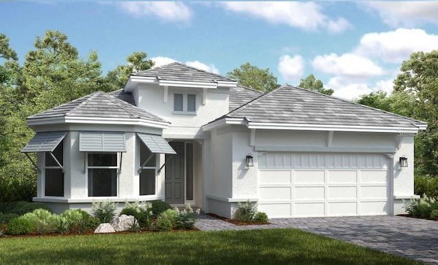 view of front of property featuring a garage and a front lawn