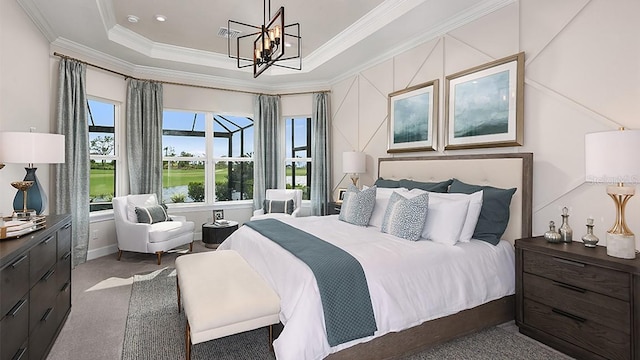 bedroom featuring a tray ceiling, an inviting chandelier, ornamental molding, and dark colored carpet