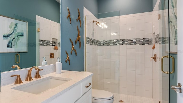 bathroom featuring vanity, an enclosed shower, and toilet