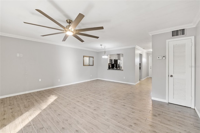 empty room with ceiling fan, ornamental molding, and light hardwood / wood-style flooring