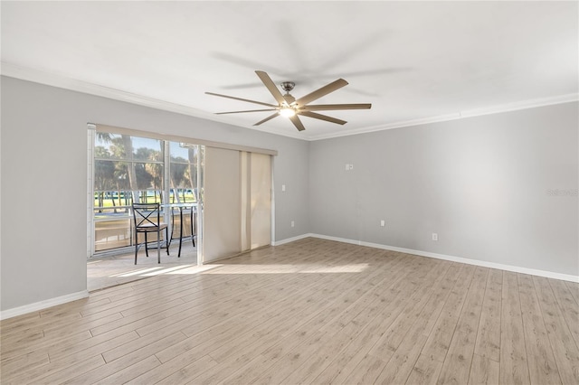 empty room featuring light hardwood / wood-style flooring, ornamental molding, and ceiling fan