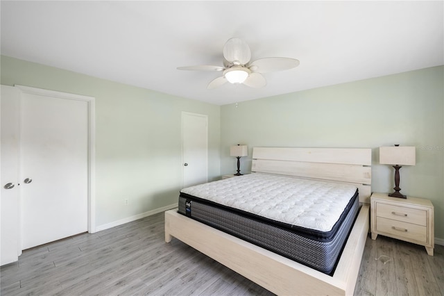 bedroom with ceiling fan and light wood-type flooring