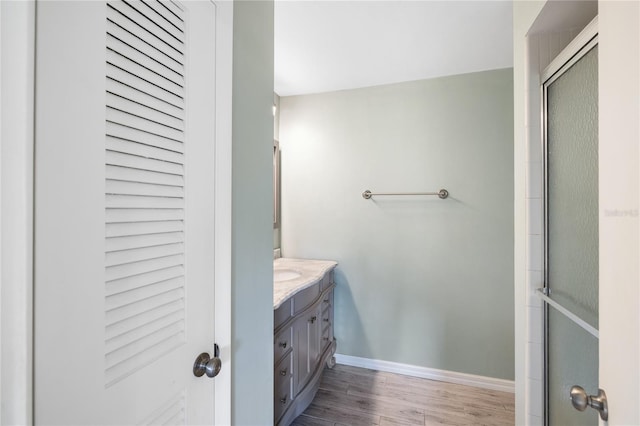 bathroom with vanity, hardwood / wood-style flooring, and walk in shower