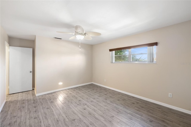 unfurnished room featuring ceiling fan and light wood-type flooring