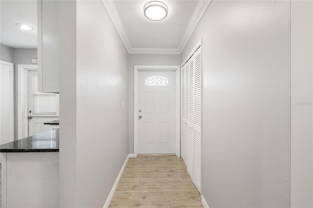 doorway with crown molding and light hardwood / wood-style flooring