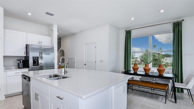 kitchen with white cabinetry, a kitchen island with sink, sink, and appliances with stainless steel finishes