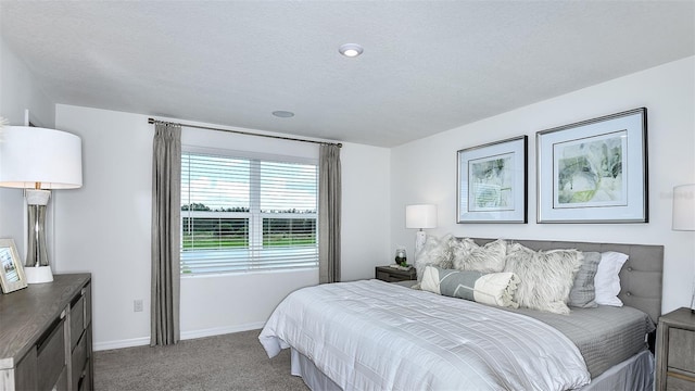 bedroom featuring carpet and a textured ceiling