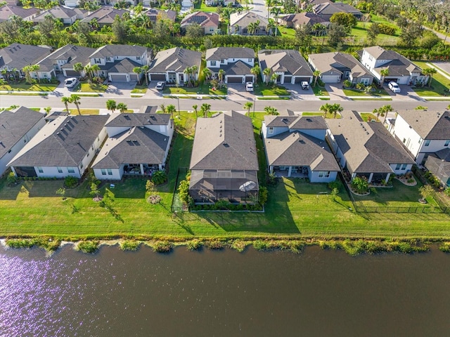 drone / aerial view featuring a water view and a residential view