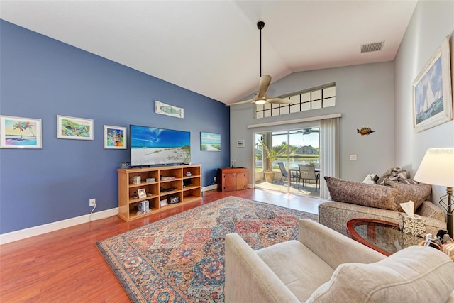 living room with hardwood / wood-style flooring, ceiling fan, and lofted ceiling