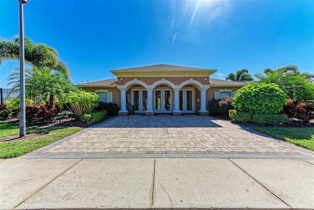 mediterranean / spanish-style house with french doors