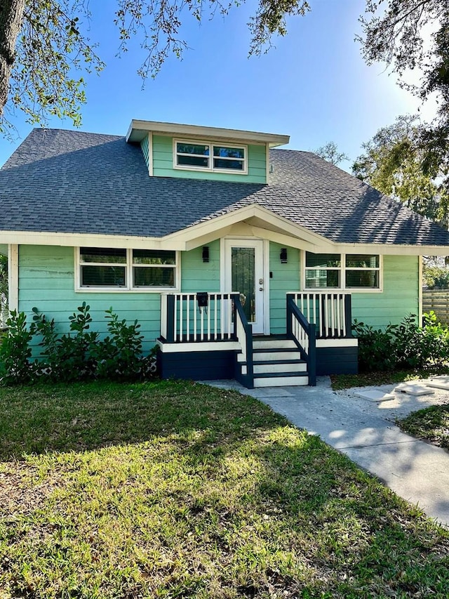 view of front of house featuring a front yard and covered porch