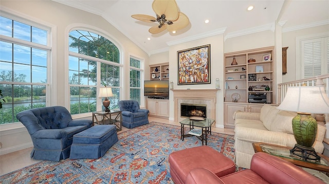 living room featuring ceiling fan, lofted ceiling, and ornamental molding