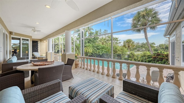 sunroom featuring ceiling fan