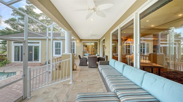 sunroom featuring ceiling fan