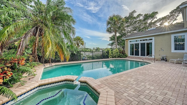 view of pool featuring a patio area and an in ground hot tub