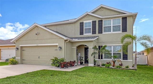 view of front of house featuring a front lawn and a garage